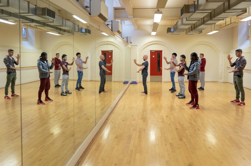 Performing arts students copying teacher