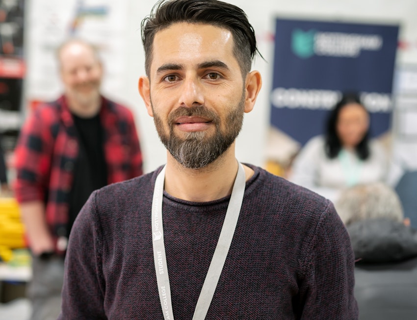 student smiling at a college event