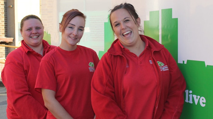 Three people stood smiling wearing Nottingham City homes uniforms