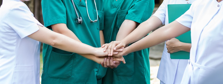 Nurses putting their hands in the middle