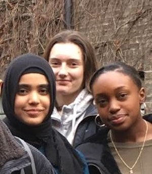 Three students smiling